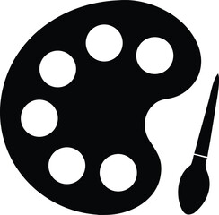 Fototapeta premium A black artist palette beside a paintbrush shows creativity and artistic inspiration