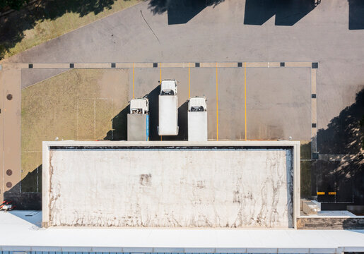 Aerial View of Trucks Parked at Small Factory Entrance