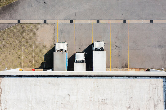Aerial View of Trucks Parked at Small Factory Entrance
