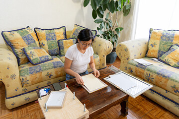 Woman framing a natural artwork as a hobby