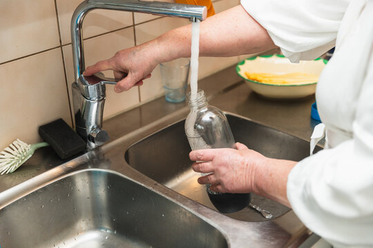 Woman using kitchen sink