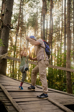 family on a forest zip line