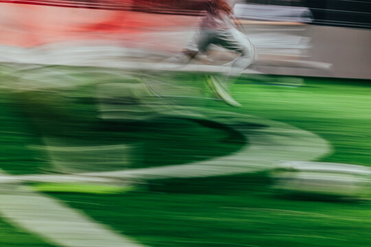 Fototapeta Motion blur of a soccer game on green turf field