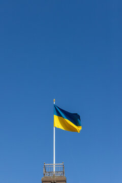 Ukrainian Flag Waving Against a Clear Blue Sky