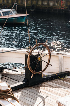 Vintage Ship&rsquo;s Wheel on a Wooden Deck