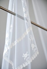 white sheer curtain with white lace on it