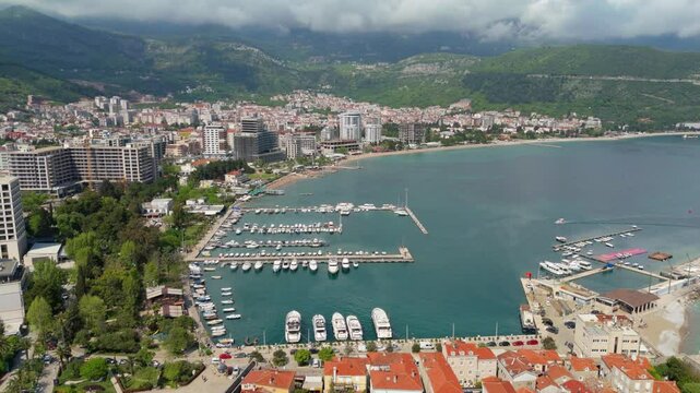 Aerial droen view Budva old town Stari harbour yachts Medieval Dubrovnik blue waters riviera mountains vacation holiday coastal Adriatic Mediterranean 