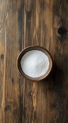 Fototapeta premium Top view of baking soda in a bowl on a wooden table with copy space