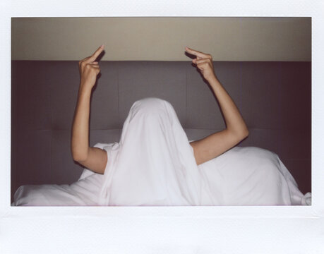 UGC Polaroid covered with bedsheet showing middle finger