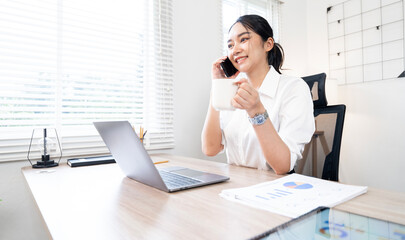 Portrait of young asian woman working with laptop at home office..