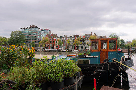 Boat house on canal in Amsterdam, alternative lifestyle 