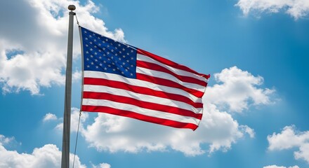 Obraz premium American Flag Waving Proudly Against Blue Sky with Clouds on Flagpole