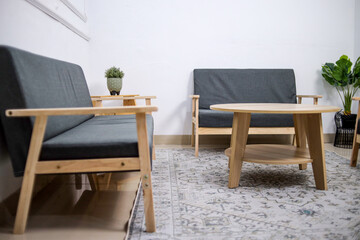 Fototapeta premium Modern Beige Lounge Chairs In A Minimalist Waiting Room With Wooden Table