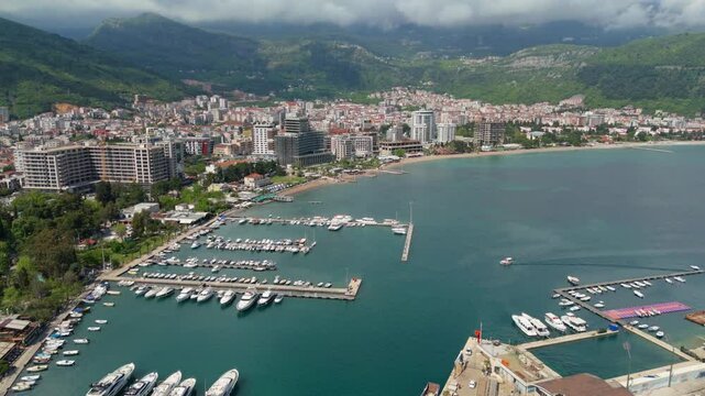 Aerial droen view Budva old town Stari harbour yachts Medieval Dubrovnik blue waters riviera mountains vacation holiday coastal Adriatic Mediterranean 