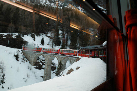 Red wagons of Bernina train seen from its window