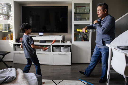 Father and Son Bonding Through Playtime Activities in Modern Room