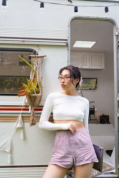 Asian female freelancer traveling in a cozy camper