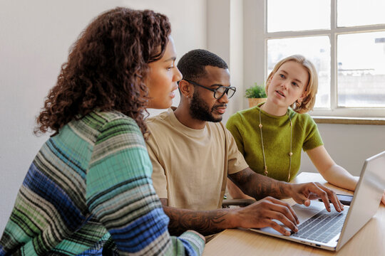 Marketing team working on laptop in the office