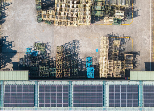 Aerial View of Metal Factory with Stacks and Solar Panels