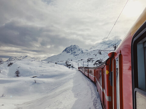 Famous red Bernina train in snowy landscape