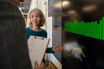 Business professionals analyzing financial data on digital screen