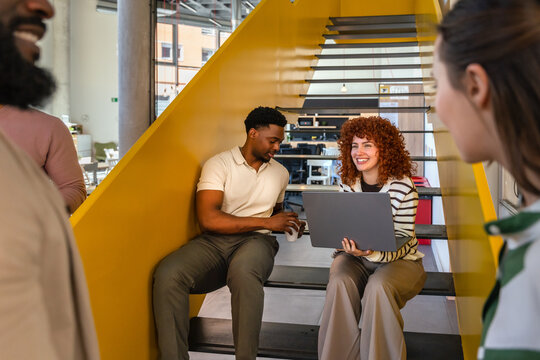 Collaborative brainstorming session on office staircase