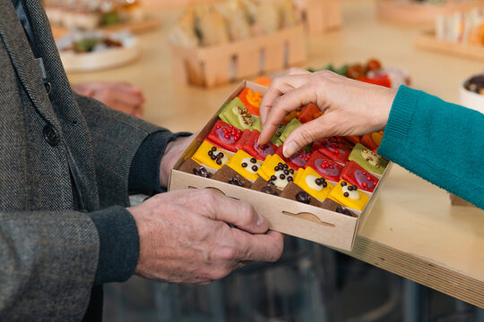Colorful Bite-Sized Pastry Selection Handover Moment
