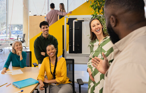 Diverse team enjoys collaborative discussion in office setting