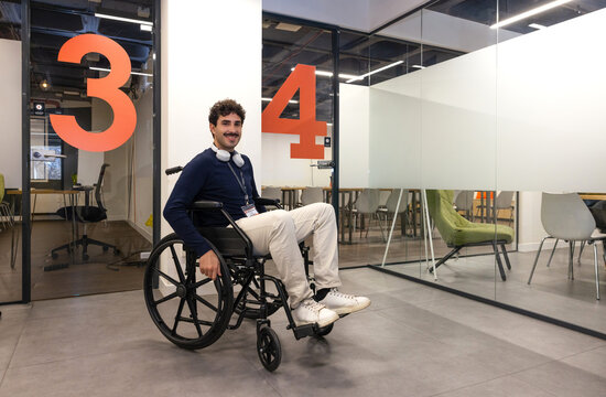 Young professional in a wheelchair in a modern office setting