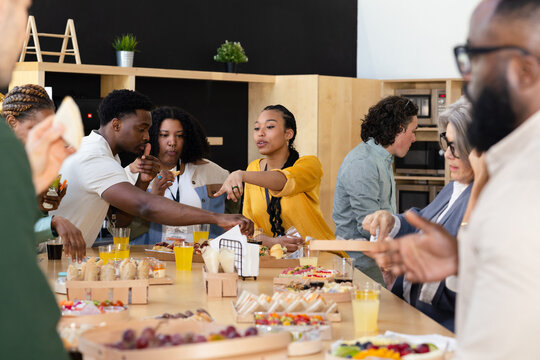 Office social gathering with diverse colleagues and snacks