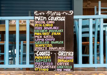 Traditional Greek cuisine written on restaurant menu board