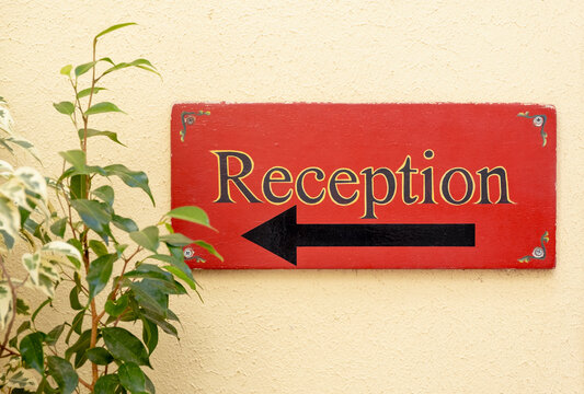 Vintage reception sign with arrow on the wall