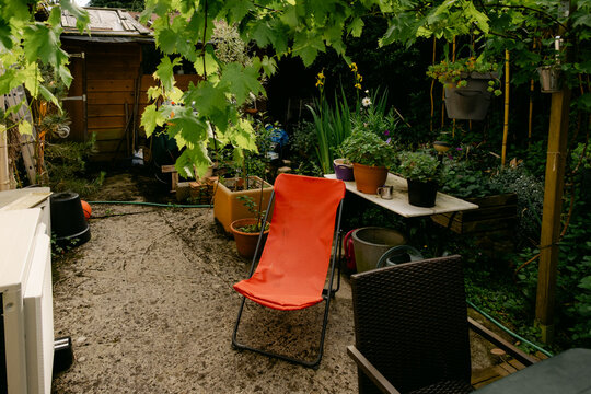 orange/ red folding  lounge chair on patio 