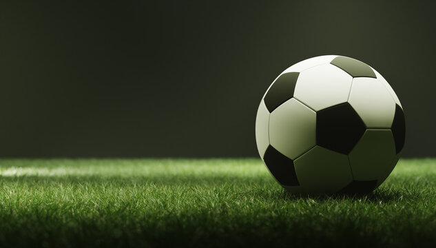 Soccer ball on a green field at night
