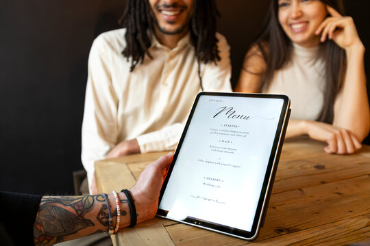 Wedding planner showing menu options to couple 