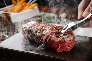 Cutting a steak on a hot stone
