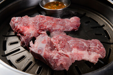 The pork is being grilled.
