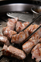 The pork is being grilled.
