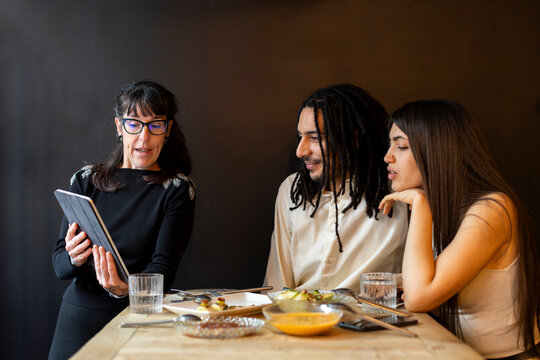 Couple discussing wedding menu with wedding planner 