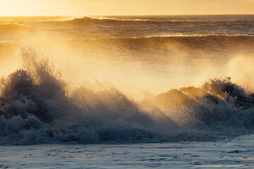 Ocean Waves Crashing with Golden Sunlight