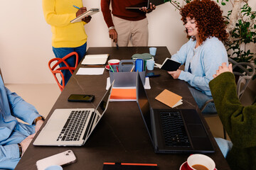 Shared desk of a team of office workers during a brainstorming meeting
