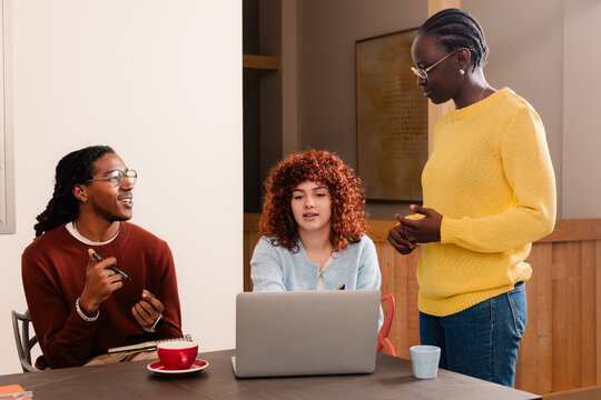 Colleagues receiving feedback from a supervisor during a presentation