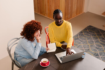 Co-workers sharing a drink and a common chat while reviewing work
