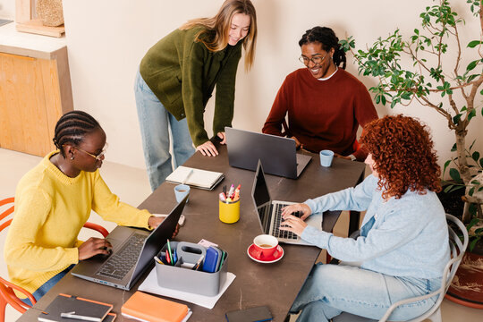 Group of professionals happily discuss ideas in a meeting room