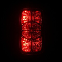 Obraz premium red tail light of car closeup in the dark night