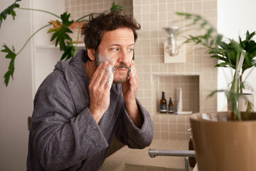 Man washing his face with soap