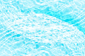 Blue water with ripples on the surface. Defocus blurred transparent blue colored clear calm water surface texture with splashes and bubbles. Water waves with shining pattern texture background.