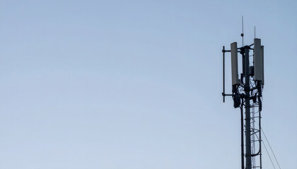 a tall cell tower standing against a clear sky.