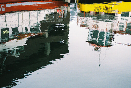 Film photo of reflection of boats in the water  Portland Harbor, Maine