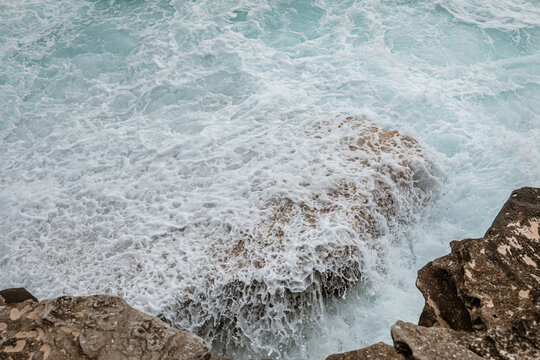 Choppy ocean waves meeting a rocky shore  in Australia
